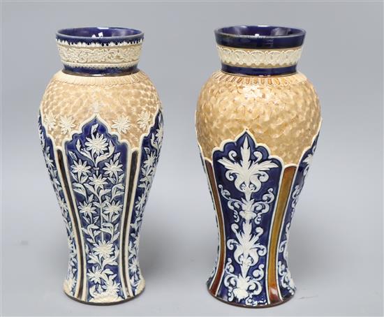 Two similar Doulton Lambeth baluster vases, c.1900, each decorated with arched panels of foliage and gilt scrolls to the shoulder H. 28